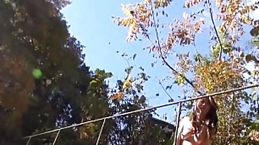 Japanese brunette Maki Hojo is naked and masturbating outdoors